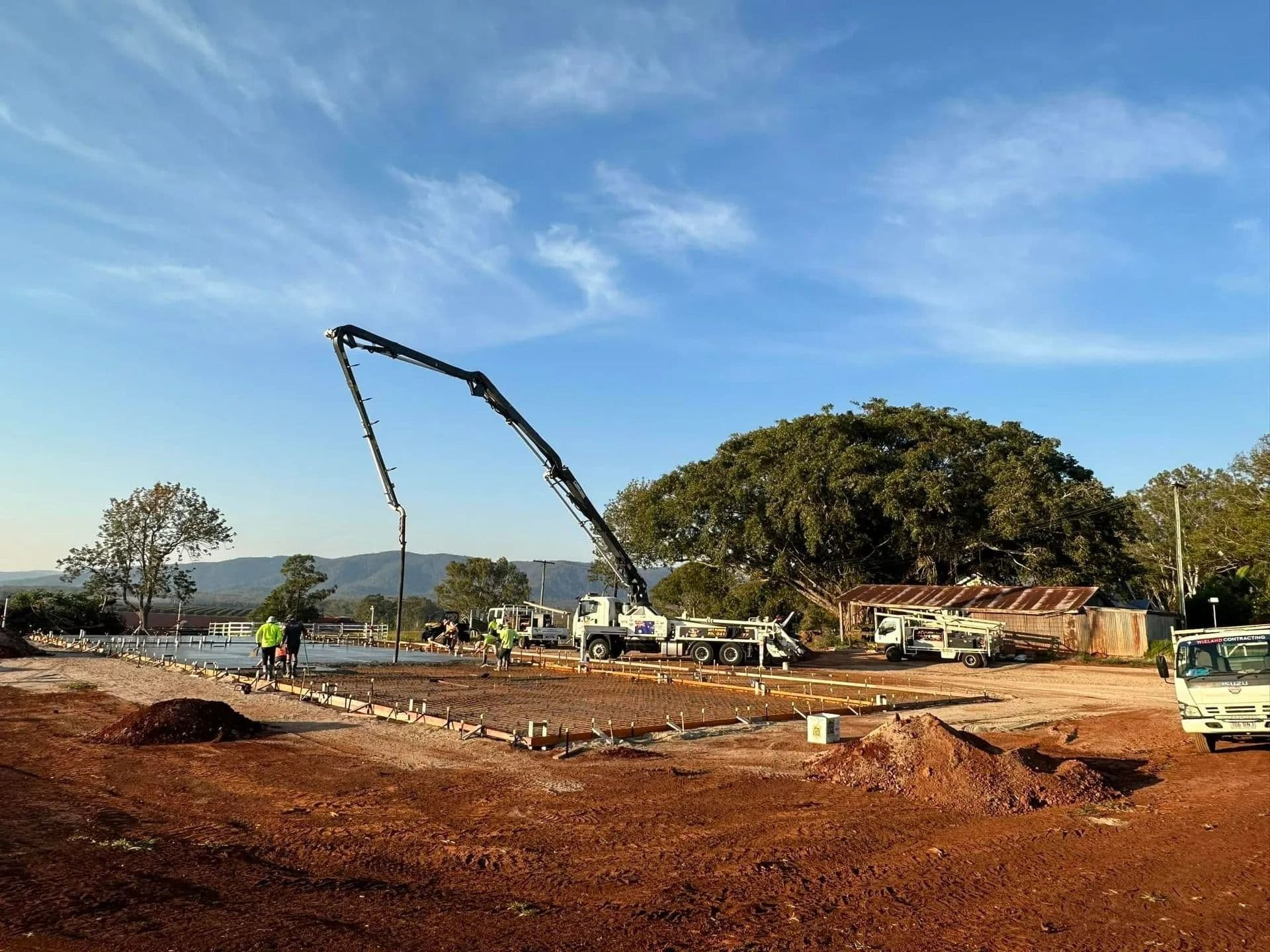 Construction Site With a Concrete Pump Truck Pouring Cement — Far Northern Concrete Pumping in Tablelands, QLD