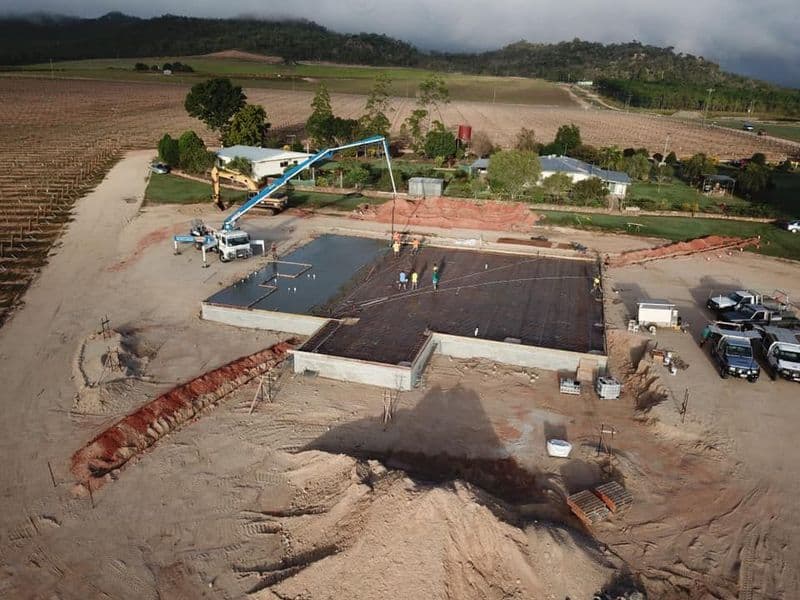 Construction Site With a Concrete Slab Being Poured, Featuring a Pump Truck — Far Northern Concrete Pumping in Mareeba, QLD