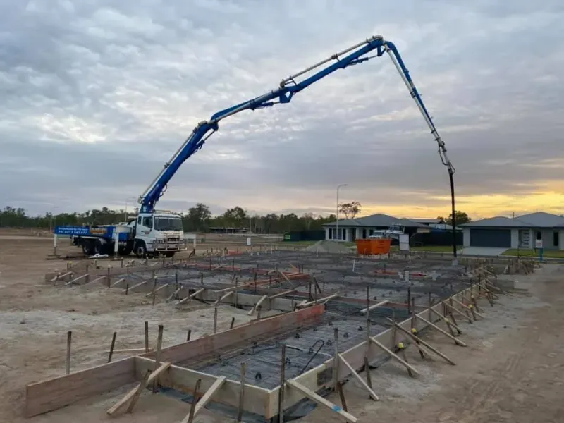 Concrete pump truck pouring concrete into a prepared foundation — Far Northern Concrete Pumping in Mareeba, QLD