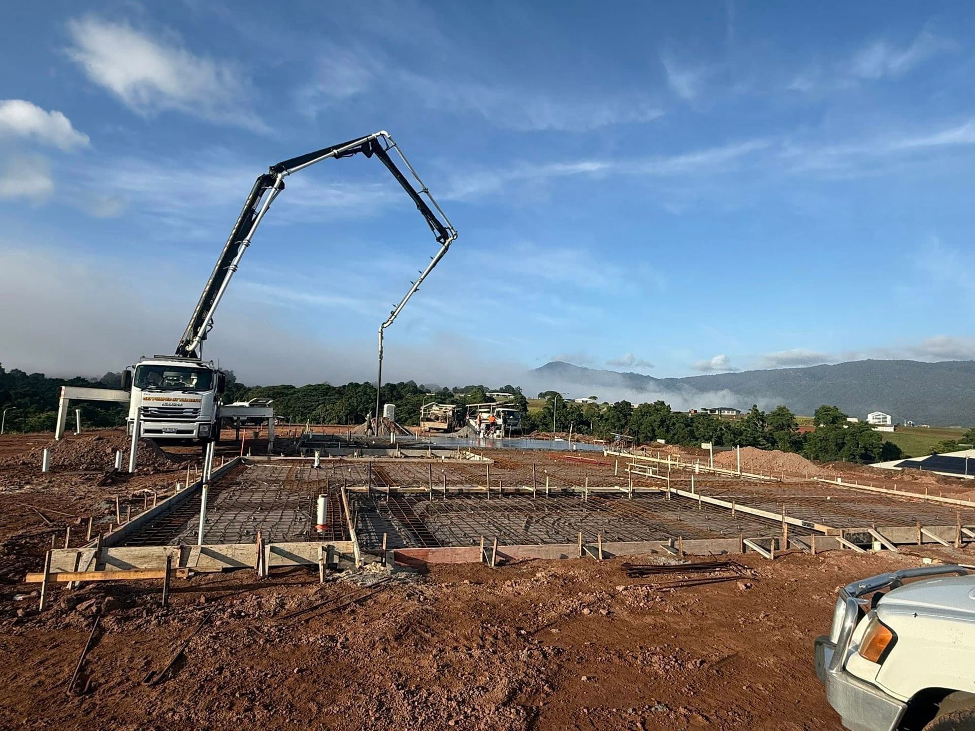 Concrete Pump Truck Pouring Concrete Into a Prepared Foundation